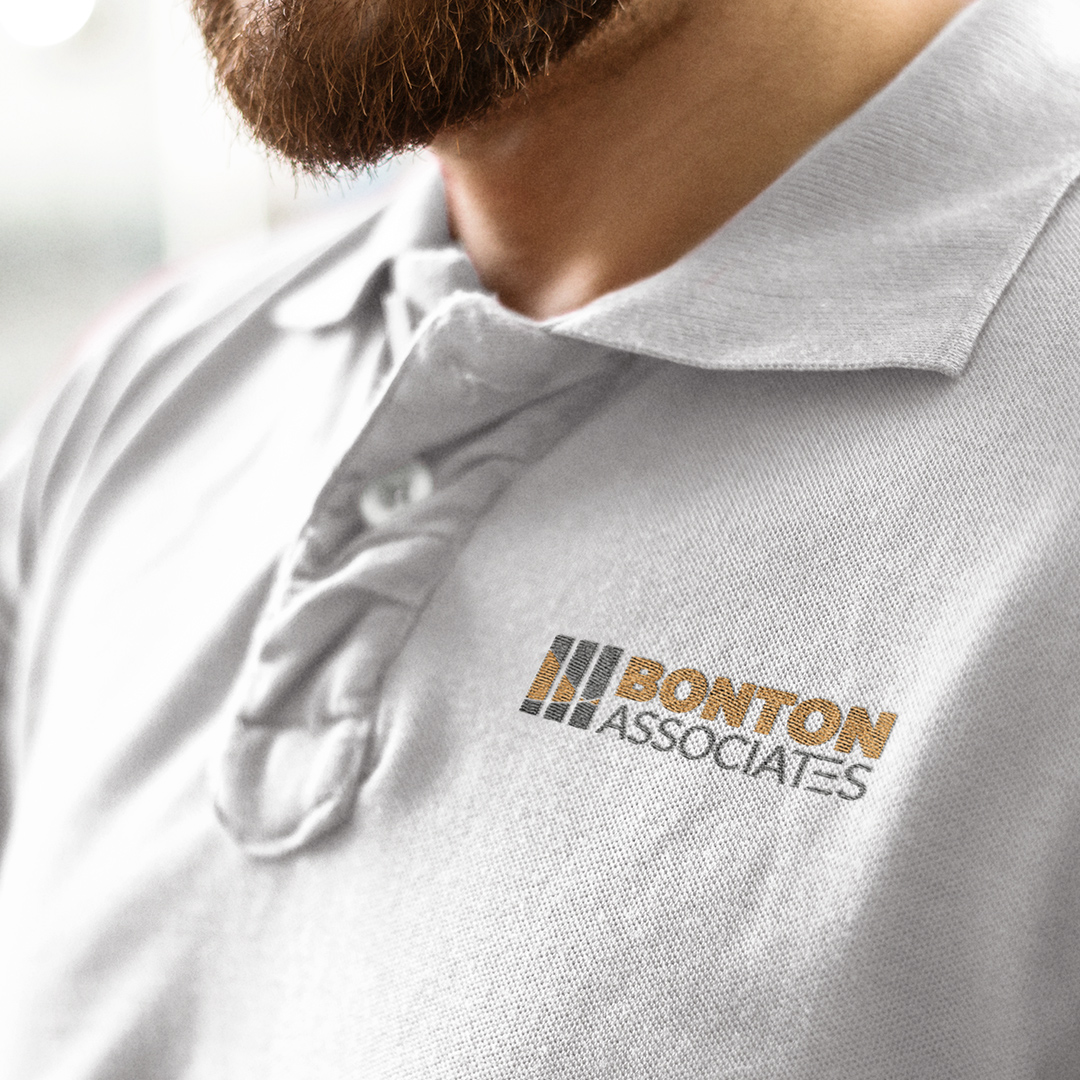 A man wearing a Bonton Associates polo shirt